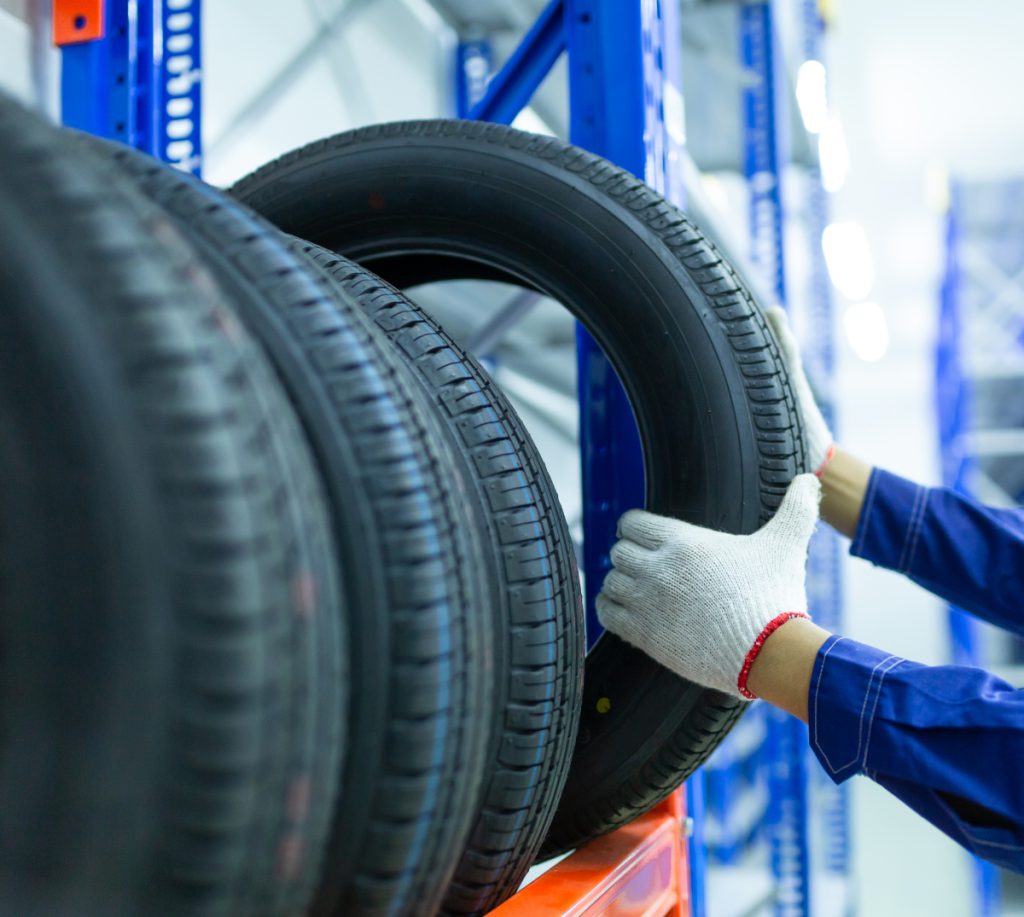 Mechanic picking out a tyre from stock - Reserve Tyres Northampton